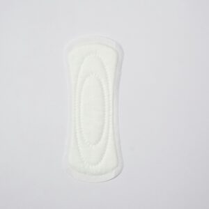 Top view of a sanitary pad on a white surface, highlighting feminine hygiene essentials.